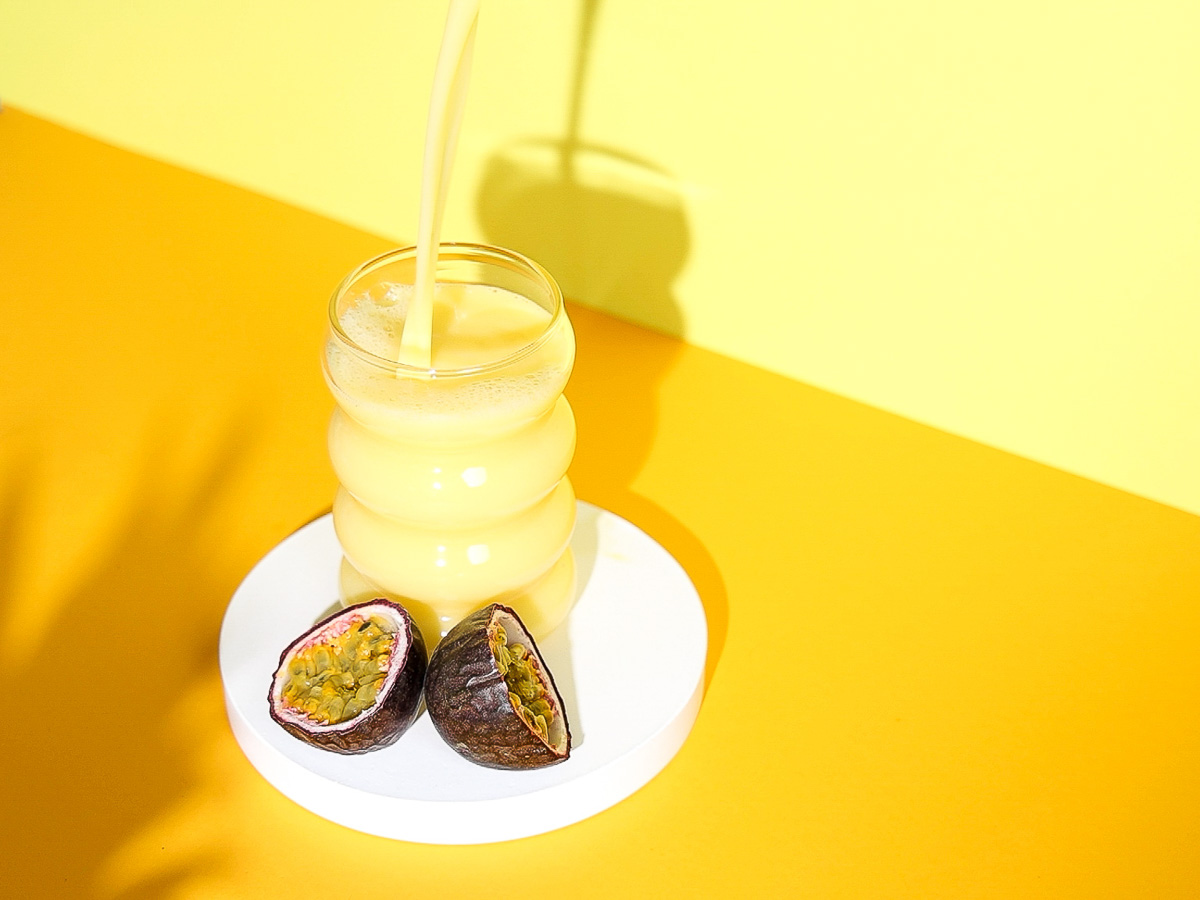 Glas, in welches Mellow Yellow Drink eingegossen wird